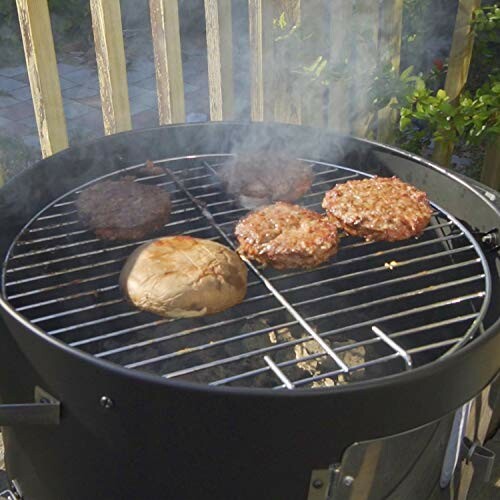 Outdoor grill with burgers and a mushroom cooking on it.