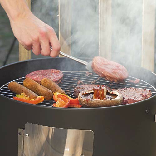 Person grilling burgers, sausages, and vegetables on a barbecue