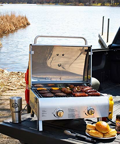 Pit Boss Grills 75275 Stainless Steel Two-Burner Portable Grill near a lake