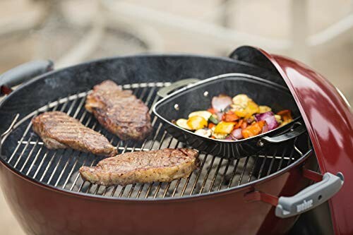 Grill with steaks and vegetables in a pan