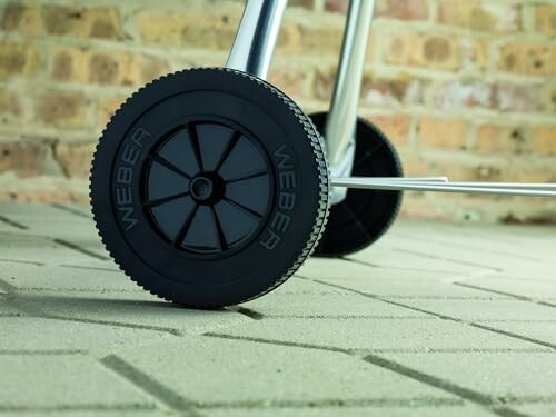 Close-up of Weber grill wheels on a patio